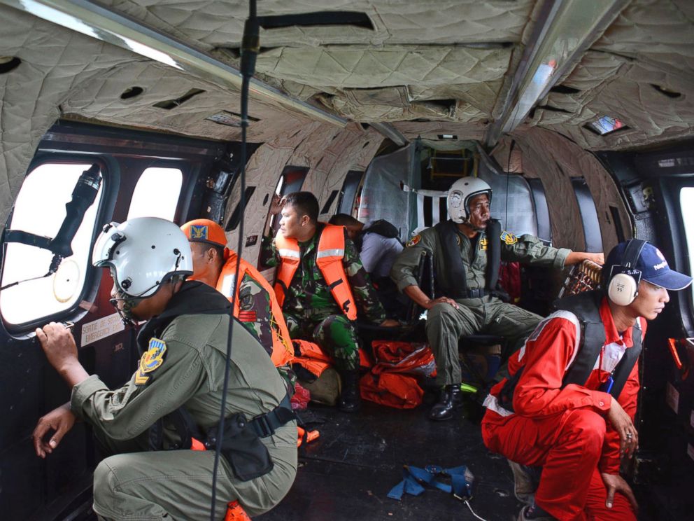 PHOTO: Crew members of an Indonesian Air Force Super Puma helicopter of the 6th Air Squadron look out of the windows during a search operation for the victims of AirAsia Flight 8501 over Java Sea, Indonesia, Jan. 1, 2015.