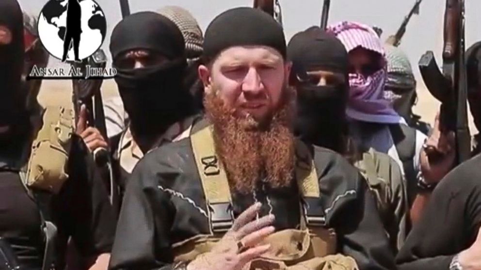 PHOTO: This image from a video posted during the weekend of June 28, 2014 by the Islamic State and the Levant (ISIL), shows Omar al-Shishani standing among a group of fighters as they declare the elimination of the border between Iraq and Syria. 
