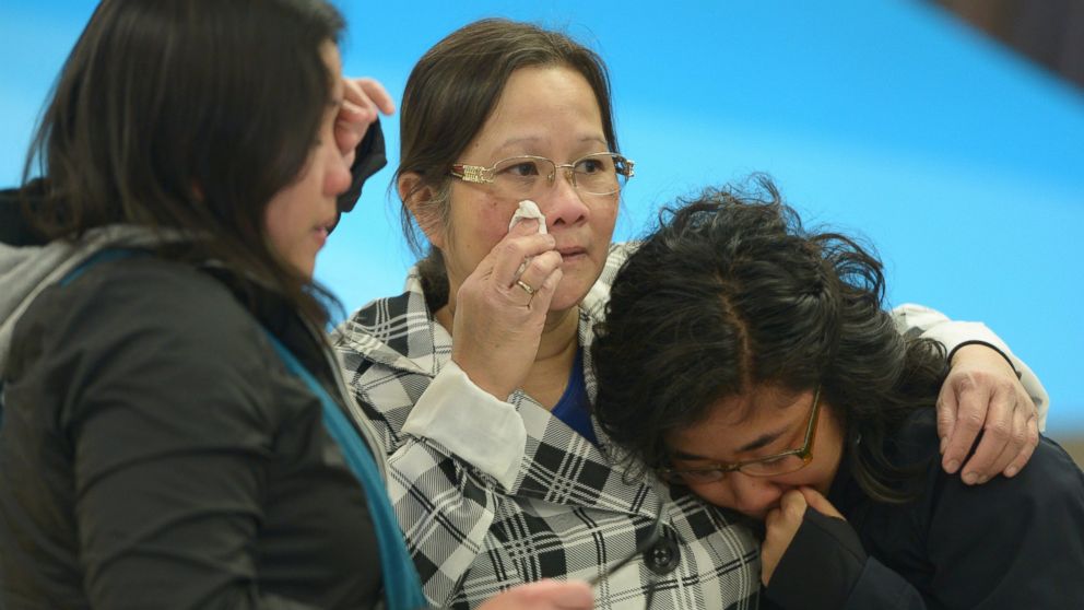 PHOTO: A woman, center, is greeted by her daughters after arriving in Edmonton from the Fort McMurray area, in Alberta, May 5, 2016. 