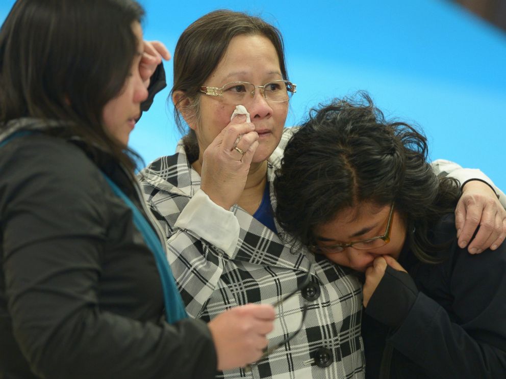 PHOTO: A woman, center, is greeted by her daughters after arriving in Edmonton from the Fort McMurray area, in Alberta, May 5, 2016.