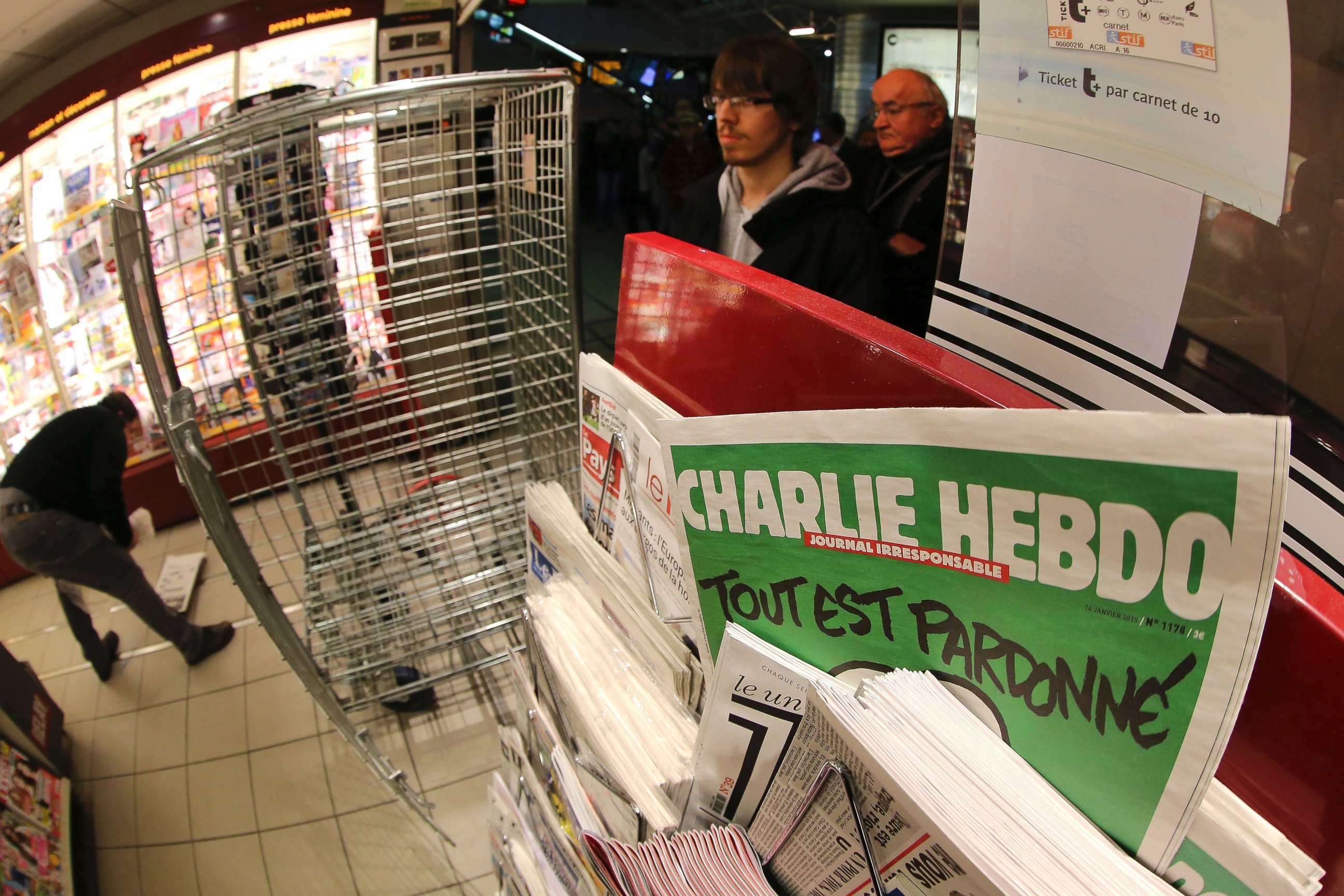 PHOTO: In this photo made with a fish-eye lens, people wait to buy the latest issue of Charlie Hebdo newspaper at a newsstand in Rennes, western France, Jan. 14, 2015.