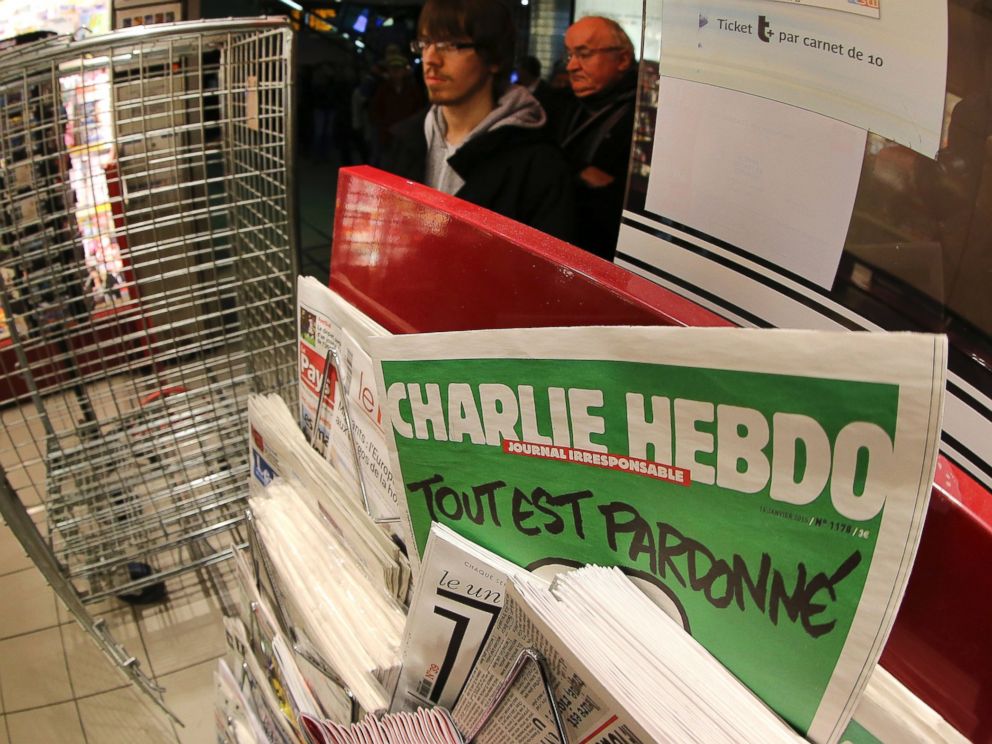 PHOTO: In this photo made with a fish-eye lens, people wait to buy the latest issue of Charlie Hebdo newspaper at a newsstand in Rennes, western France, Jan. 14, 2015.