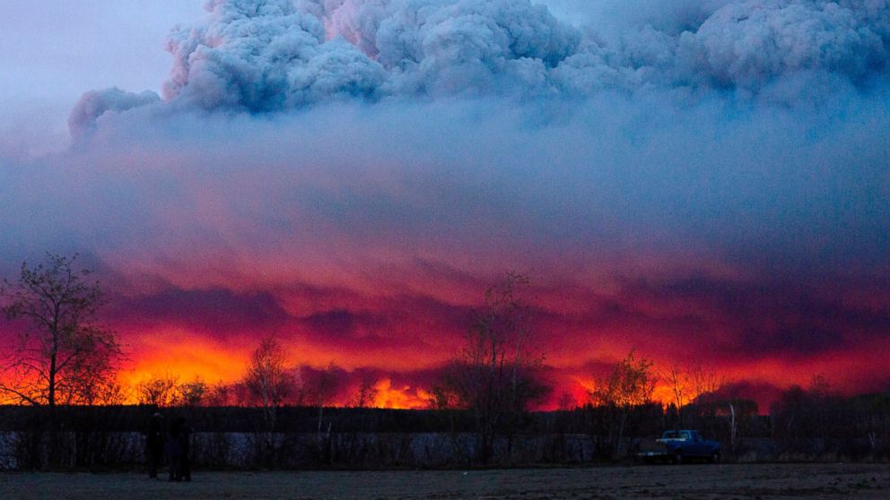 A wildfire moves towards the town of Anzac from Fort McMurray, Alberta., On May 4, 2016. Alberta declared a state of emergency Wednesday as crews frantically held back wind-whipped wildfires. Unseasonably hot temperatures combined with dry conditions have transformed the boreal forest in much of Alberta into a tinder box.