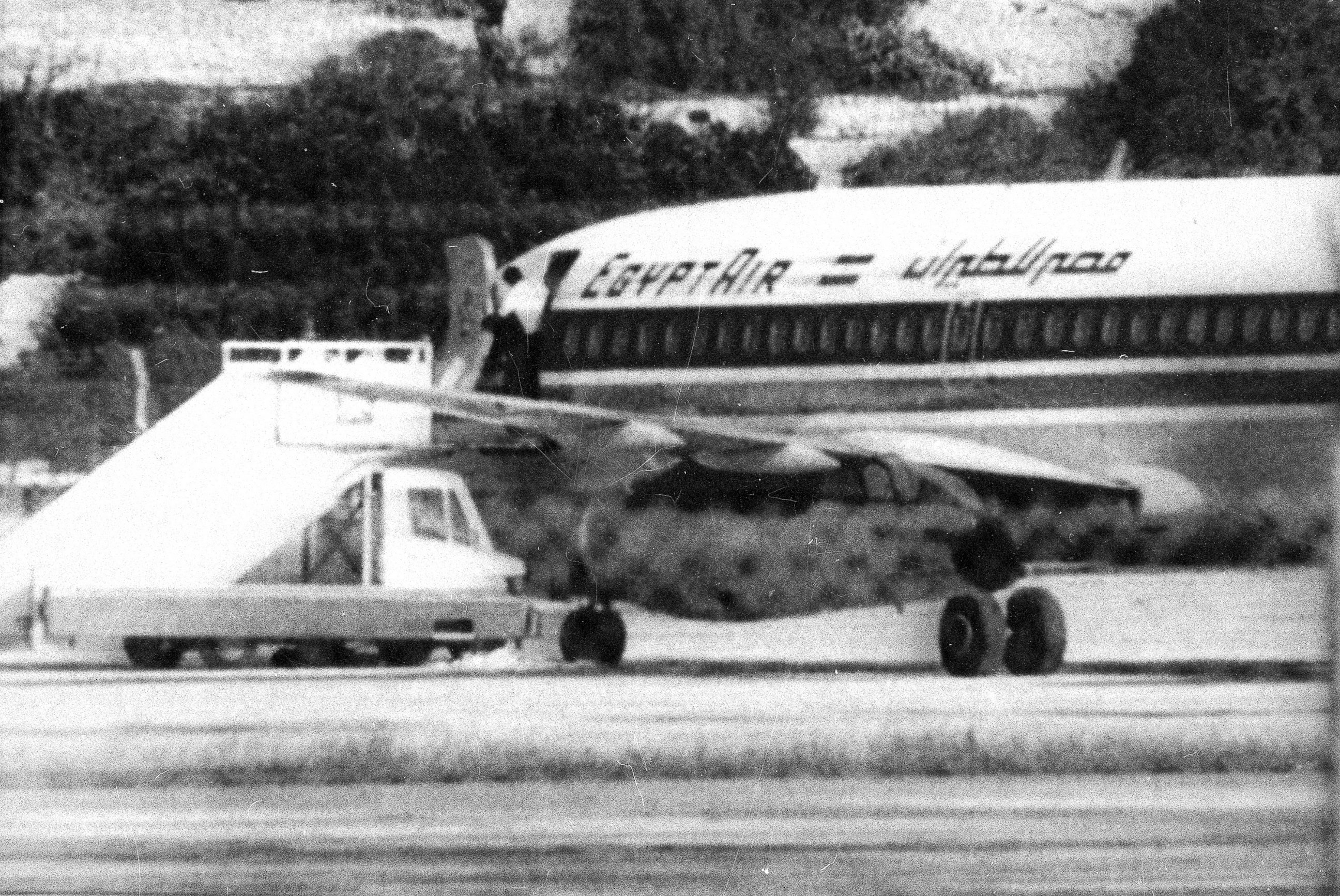 PHOTO: One of the three hijackers of EgyptAir flight 648 appears at the open doorway at Luqa airport in Valletta, Malta, Nov. 24, 1985.