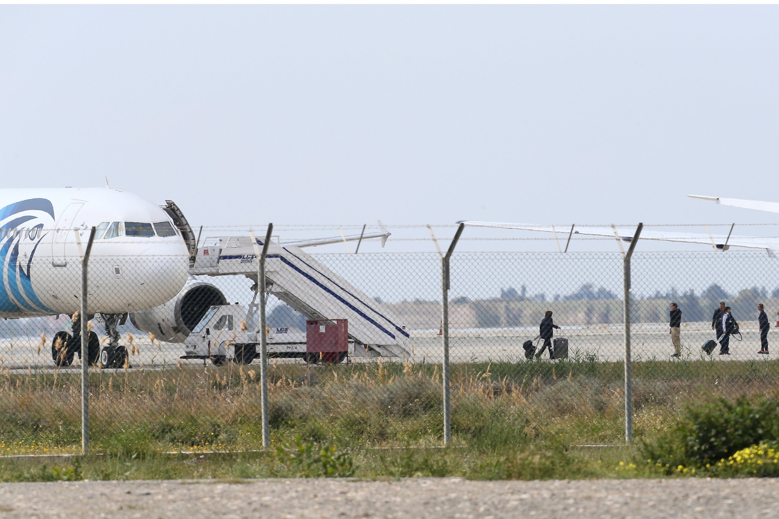 PHOTO: People leave the hijacked aircraft of EgyptAir at Larnaca airport Tuesday, March 29, 2016.