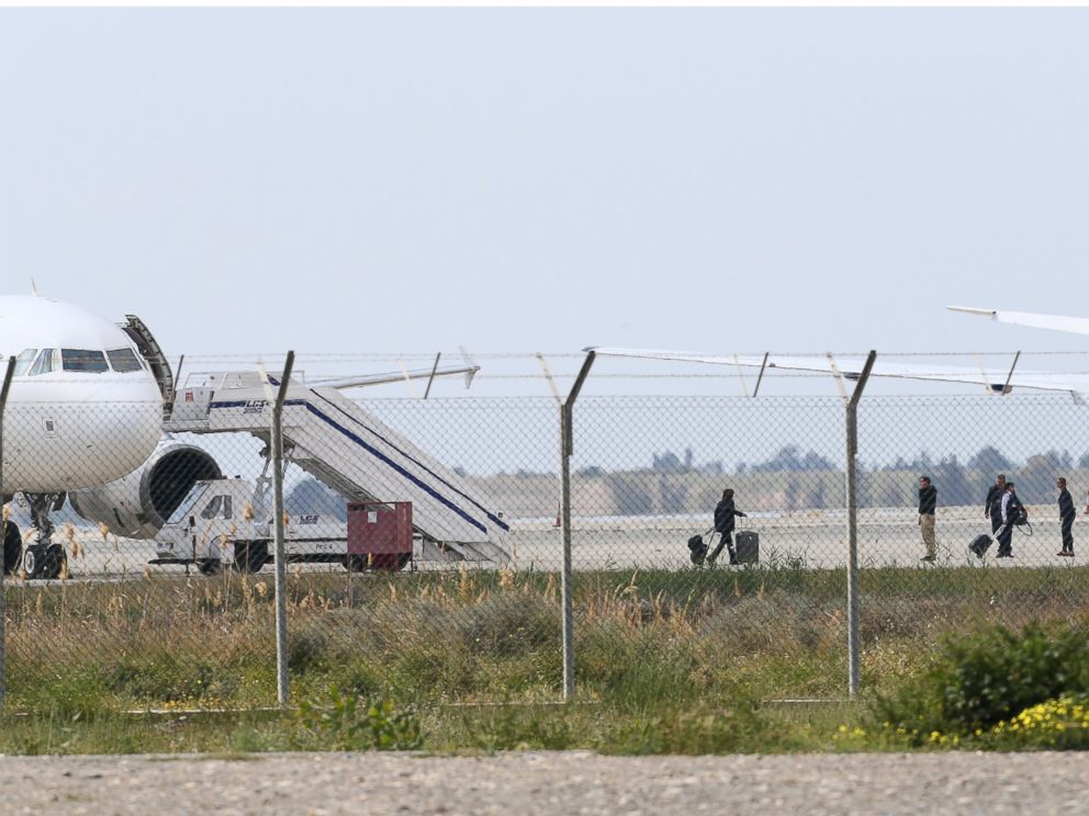 PHOTO: People leave the hijacked aircraft of EgyptAir at Larnaca airport Tuesday, March 29, 2016.