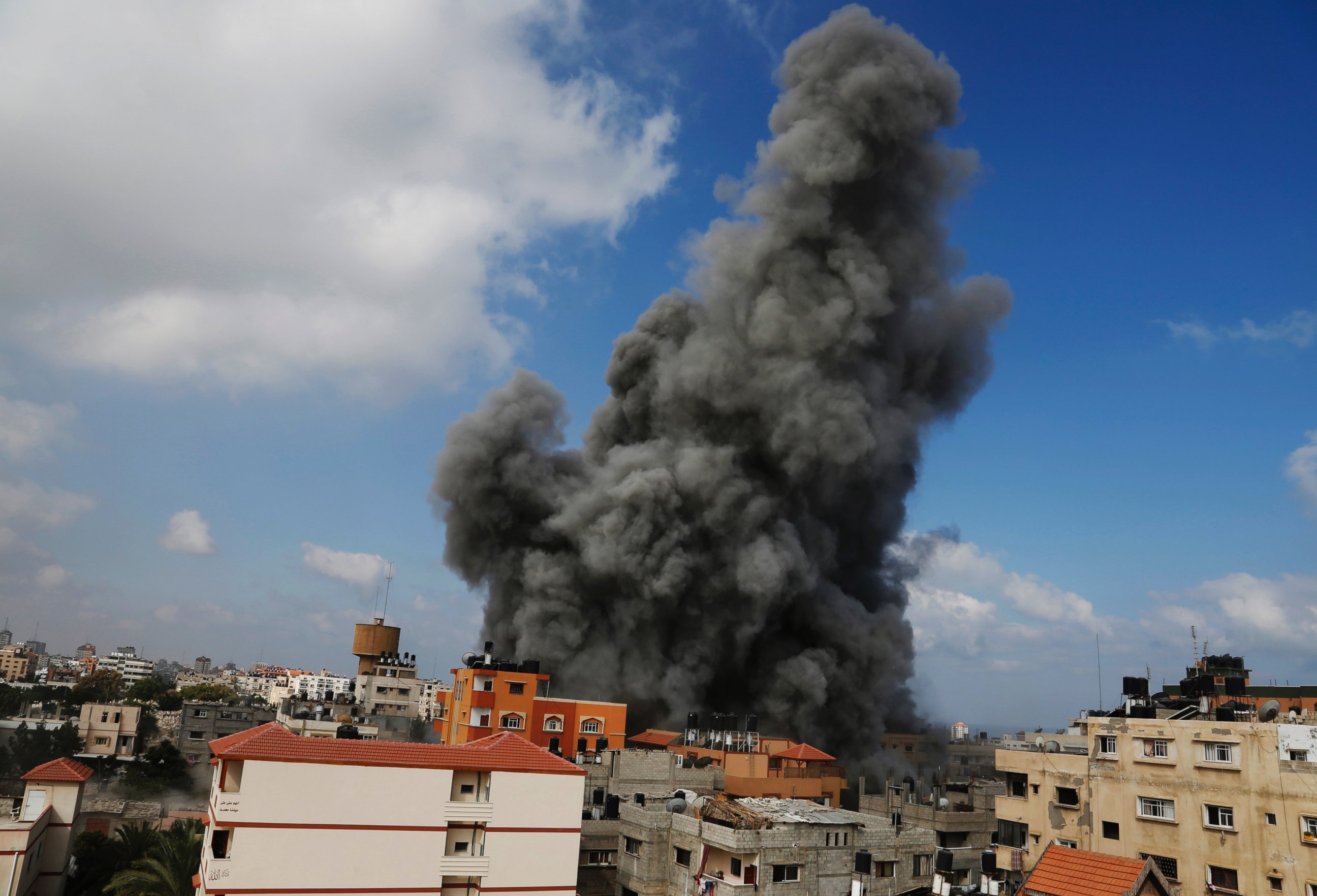 PHOTO: Smoke rises after an Israeli strike hit the offices of the Hamas movement's Al-Aqsa satellite TV station, in Gaza City, northern Gaza Strip, July 31, 2014.