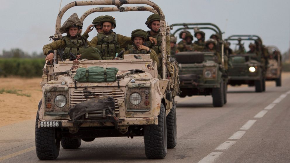 Israeli soldiers ride on a military vehicle near the Israel-Gaza Border, Thursday, July 17, 2014.