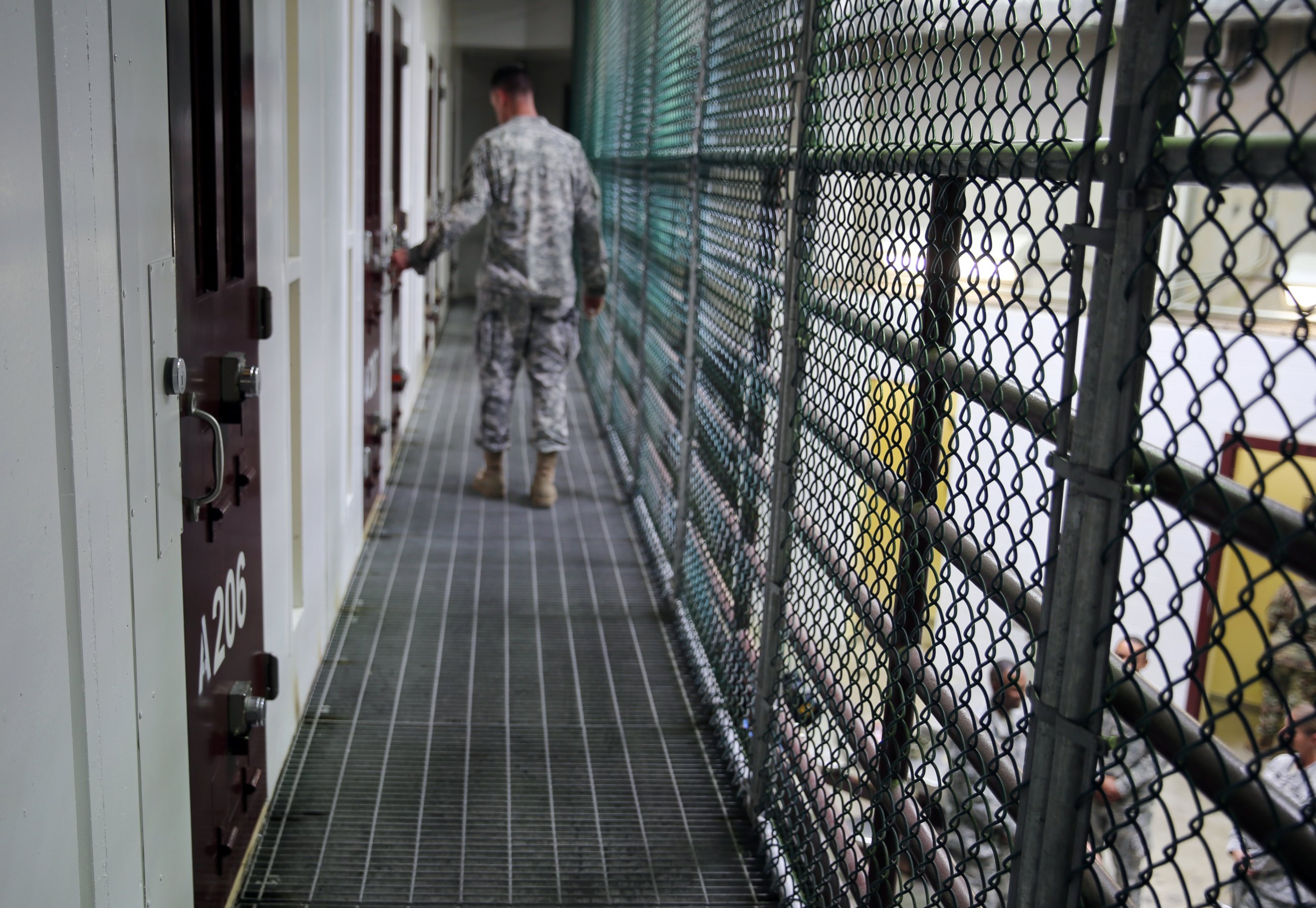 PHOTO: An Army captain walks outside unoccupied detainee cells inside Camp 6 at the U.S. detention center at Guantanamo Bay, Cuba, February 6, 2016. 