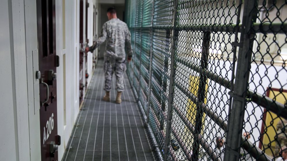 An Army captain walks outside unoccupied detainee cells inside Camp 6 at the U.S. detention center at Guantanamo Bay, Cuba, February 6, 2016. 