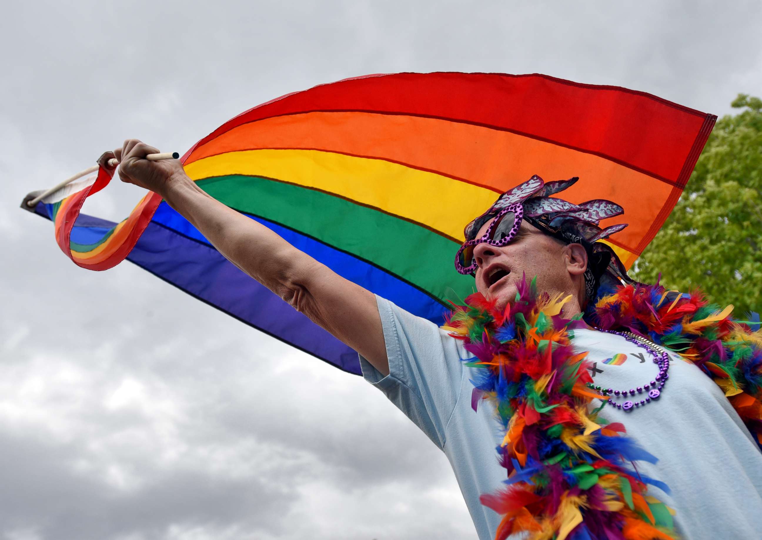 PHOTO: Ahley Newman, of Boise, waves a rainbow flag during the Boise Pride Festival, June 18, 2016 outside the Idaho State Capitol Building in Boise, Idaho. community. 