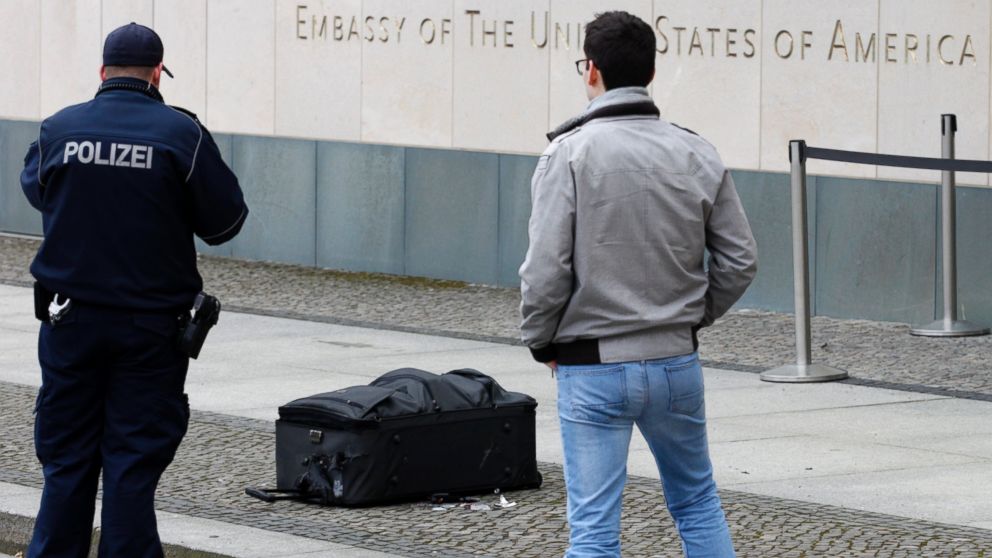 Police officers photograph a suitcase in front of the US embassy in Berlin, Germany, Friday, March 11, 2016.