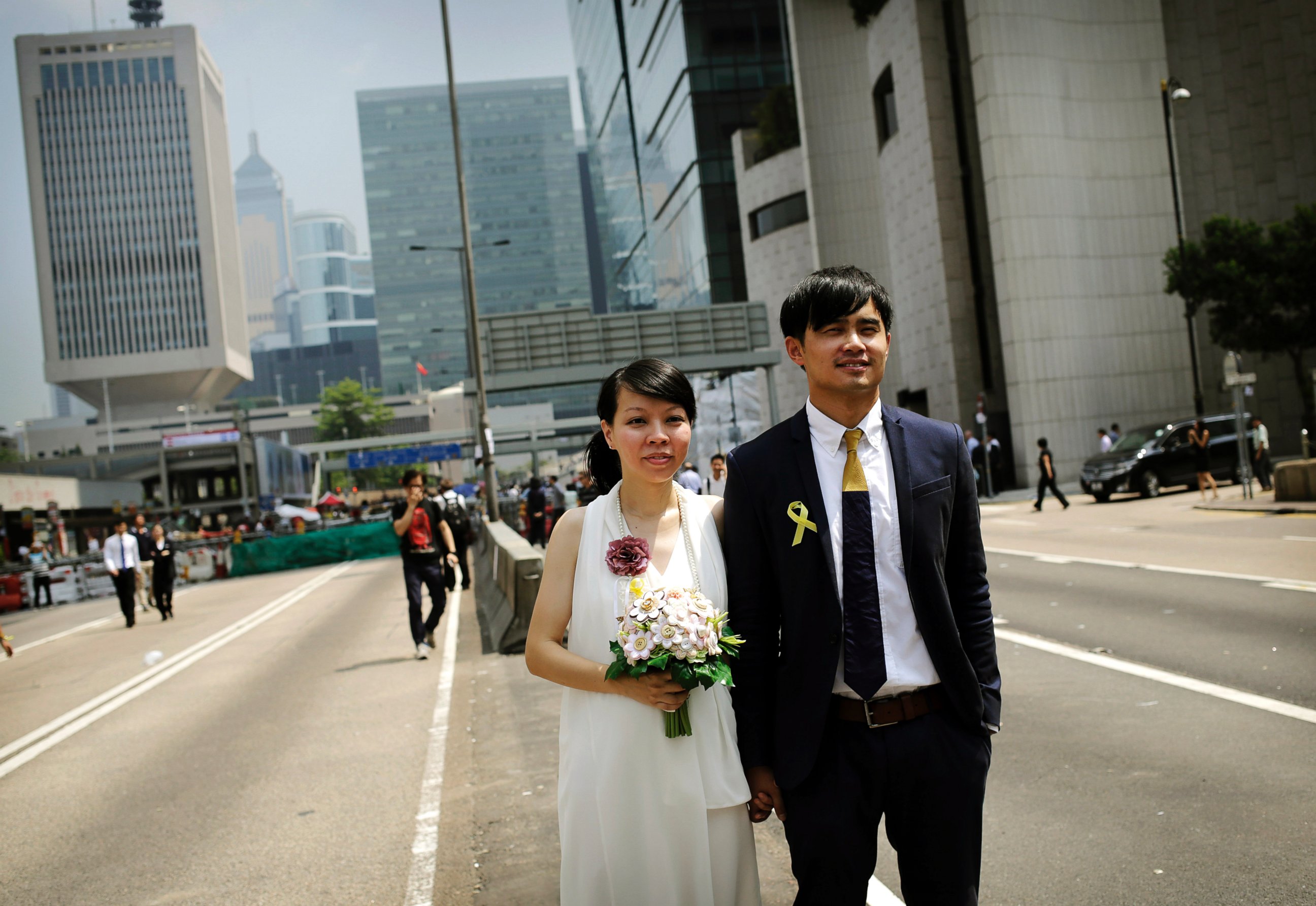 PHOTO: Newly married couple Vivian Lo and Ka Sing Fung, both 30 years old from Hong Kong, pose for their personal photographer, in front of the protest site of pro-democracy activists, Sept. 30, 2014, in Hong Kong.