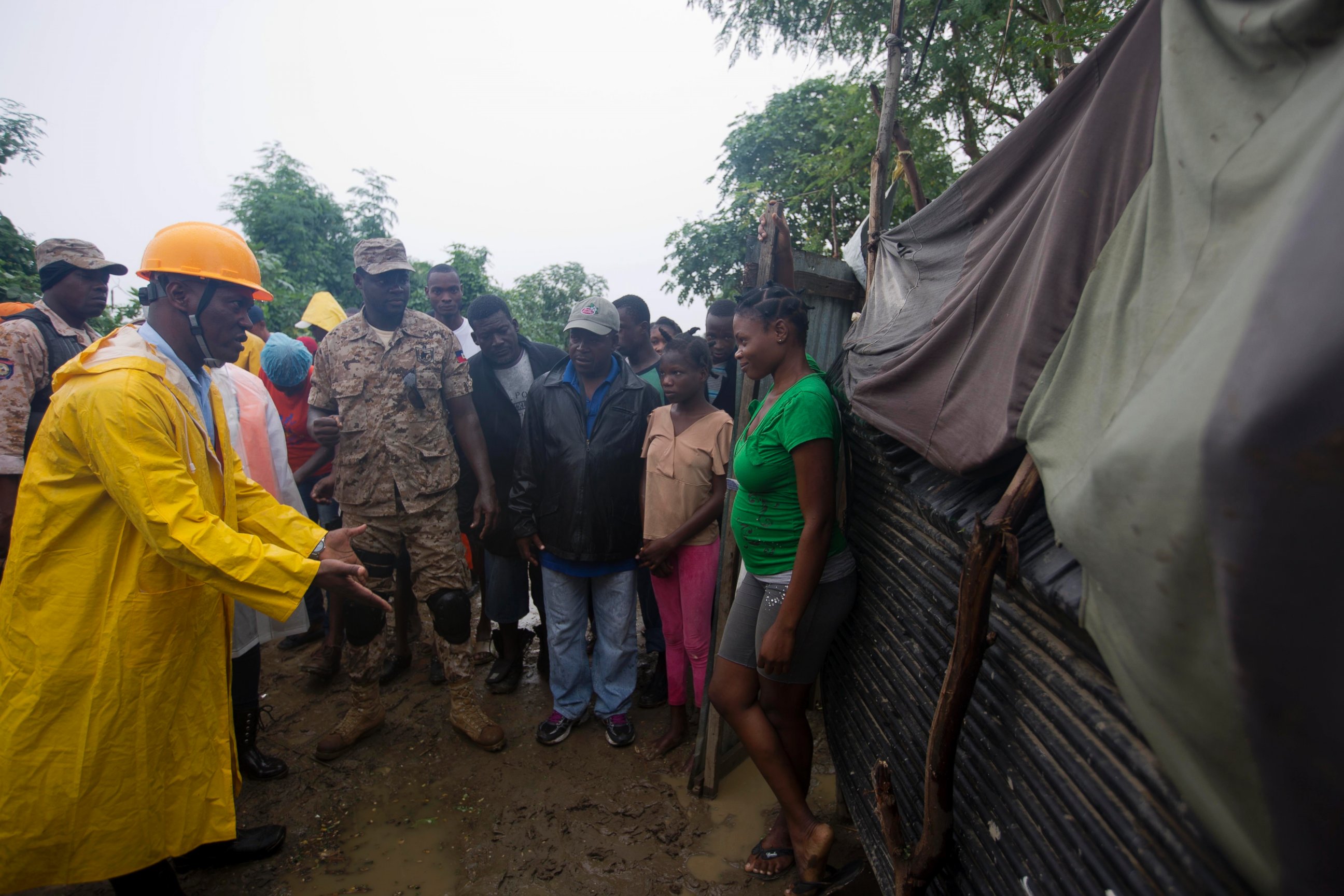 PHOTO: A civil protection worker, left, asks residents to evacuate the area near the Grise river, prior the arrival of Hurricane Matthew, in Tabarre, Haiti, Oct. 3, 2016. 