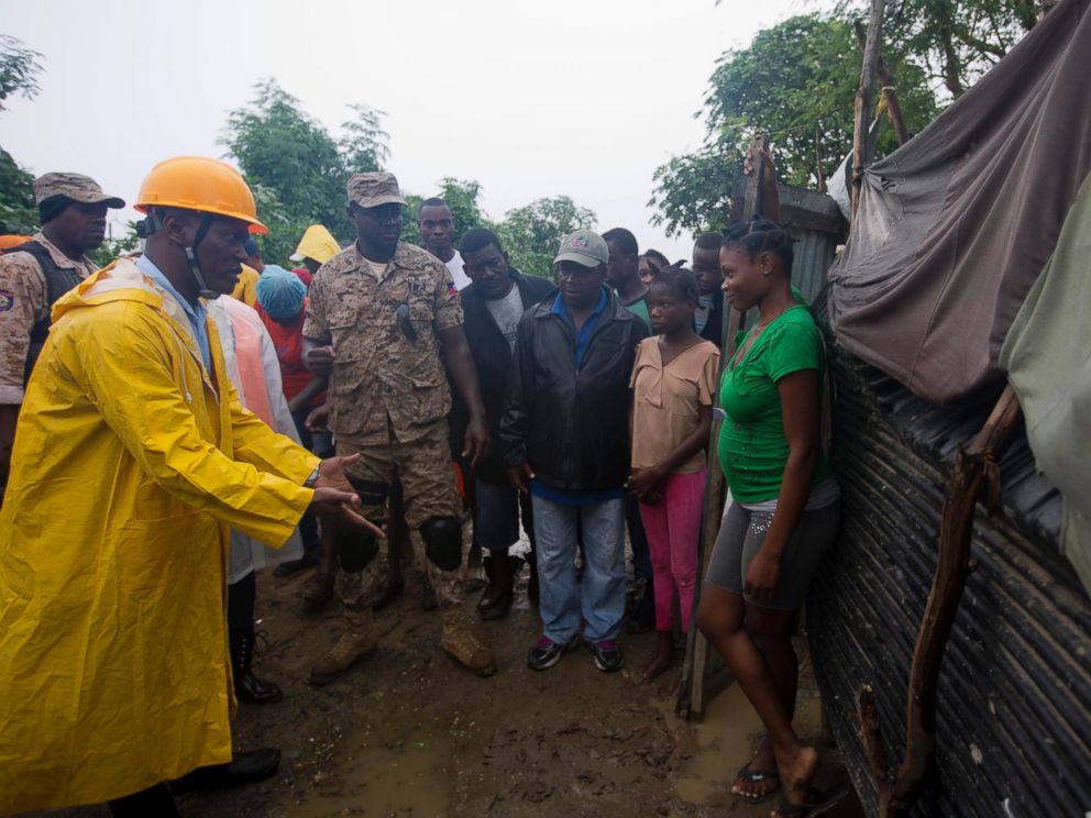 PHOTO: A civil protection worker, left, asks residents to evacuate the area near the Grise river, prior the arrival of Hurricane Matthew, in Tabarre, Haiti, Oct. 3, 2016.