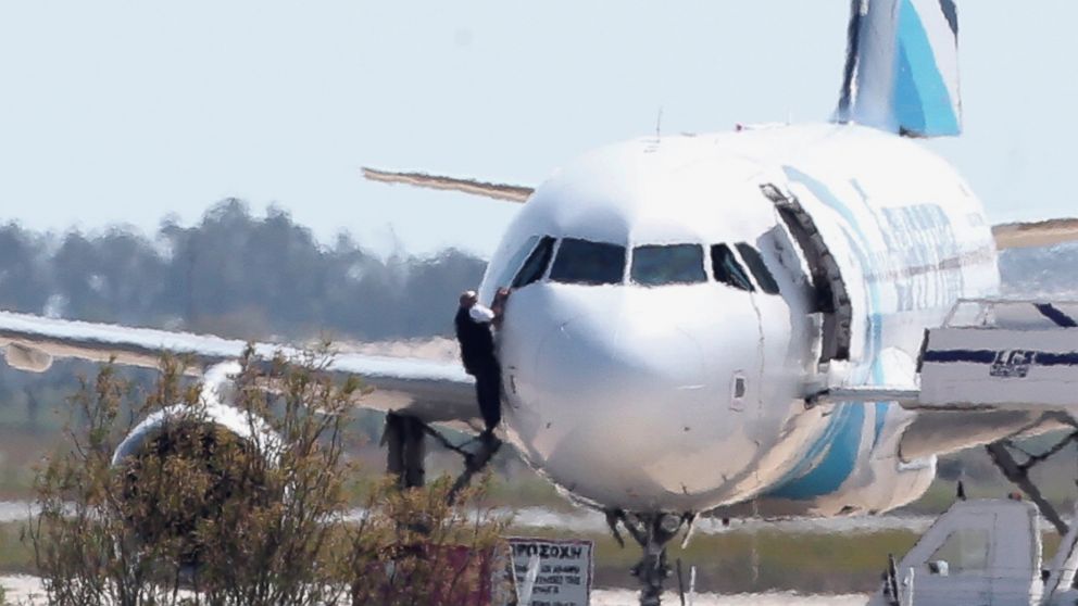 A person is seen here jumping out of the cockpit of EgyptAir Flight 181 at Larnaca airport in Cyprus, March 29, 2016.