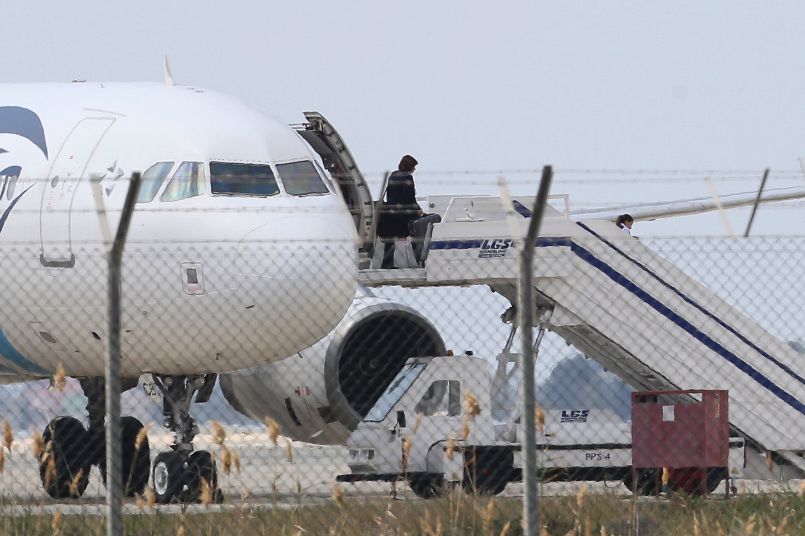 PHOTO: A passenger leaves a hijacked EgyptAir aircraft after landing at Larnaca Airport in Cyprus, March 29, 2016.