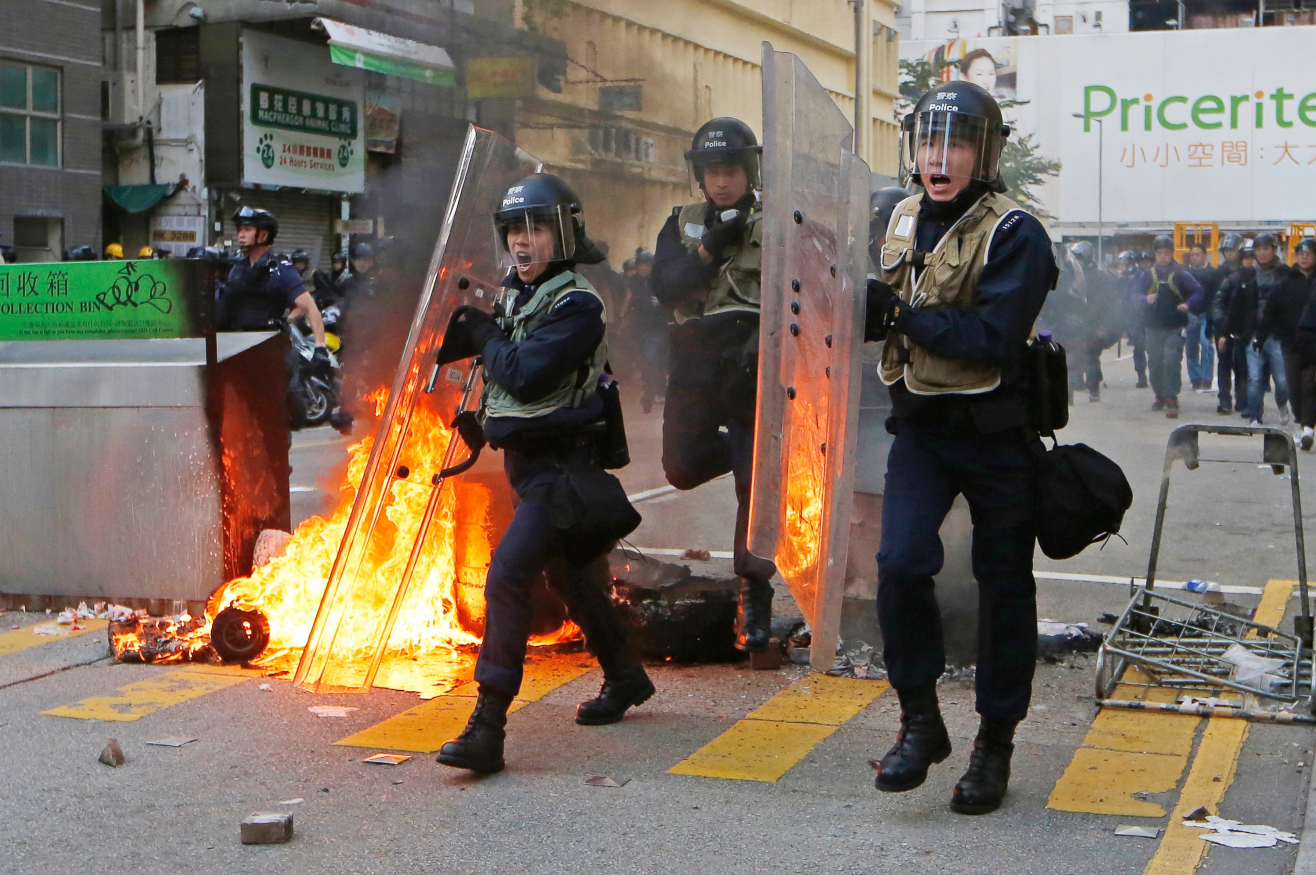 PHOTO: Riot police move forward to the protesters on a street in Mong Kok district of Hong Kong, Feb. 9, 2016.
