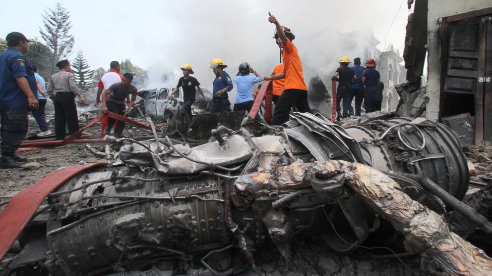 PHOTO: Firefighters and military personnel work at the site where an Air Force cargo plane crashed in Medan, North Sumatra, Indonesia, June 30, 2015.