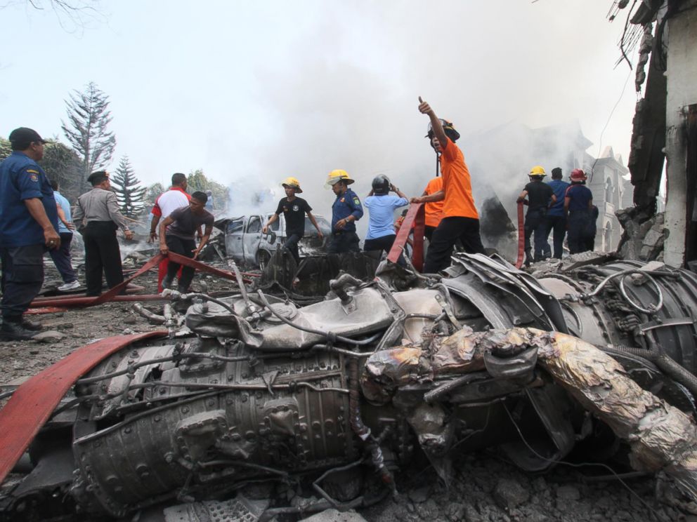 PHOTO: Firefighters and military personnel work at the site where an Air Force cargo plane crashed in Medan, North Sumatra, Indonesia, June 30, 2015.