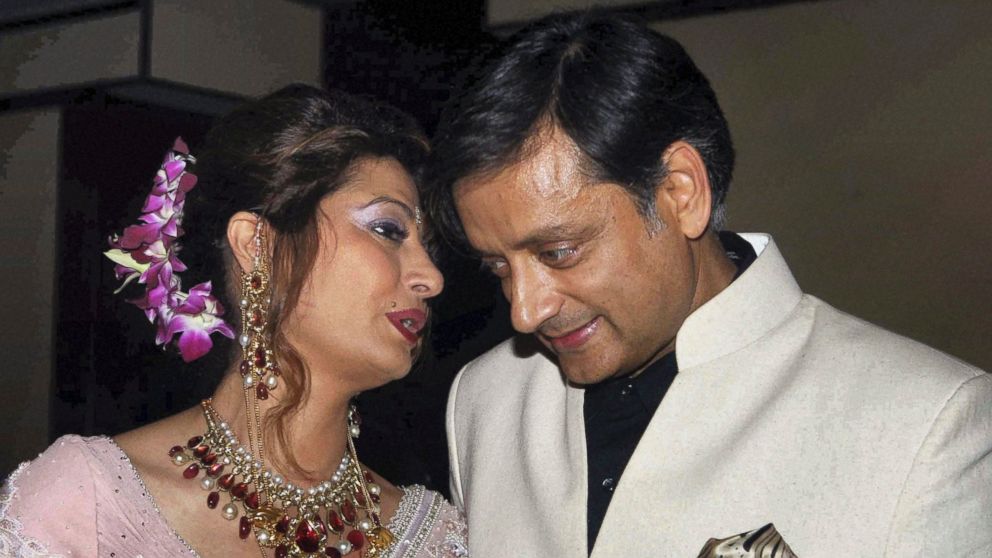 Former Indian Junior Foreign Minister Shashi Tharoor listens to his wife Sunanda Pushkar at their wedding reception in New Delhi, India, in this Sept. 4, 2010 file photo.