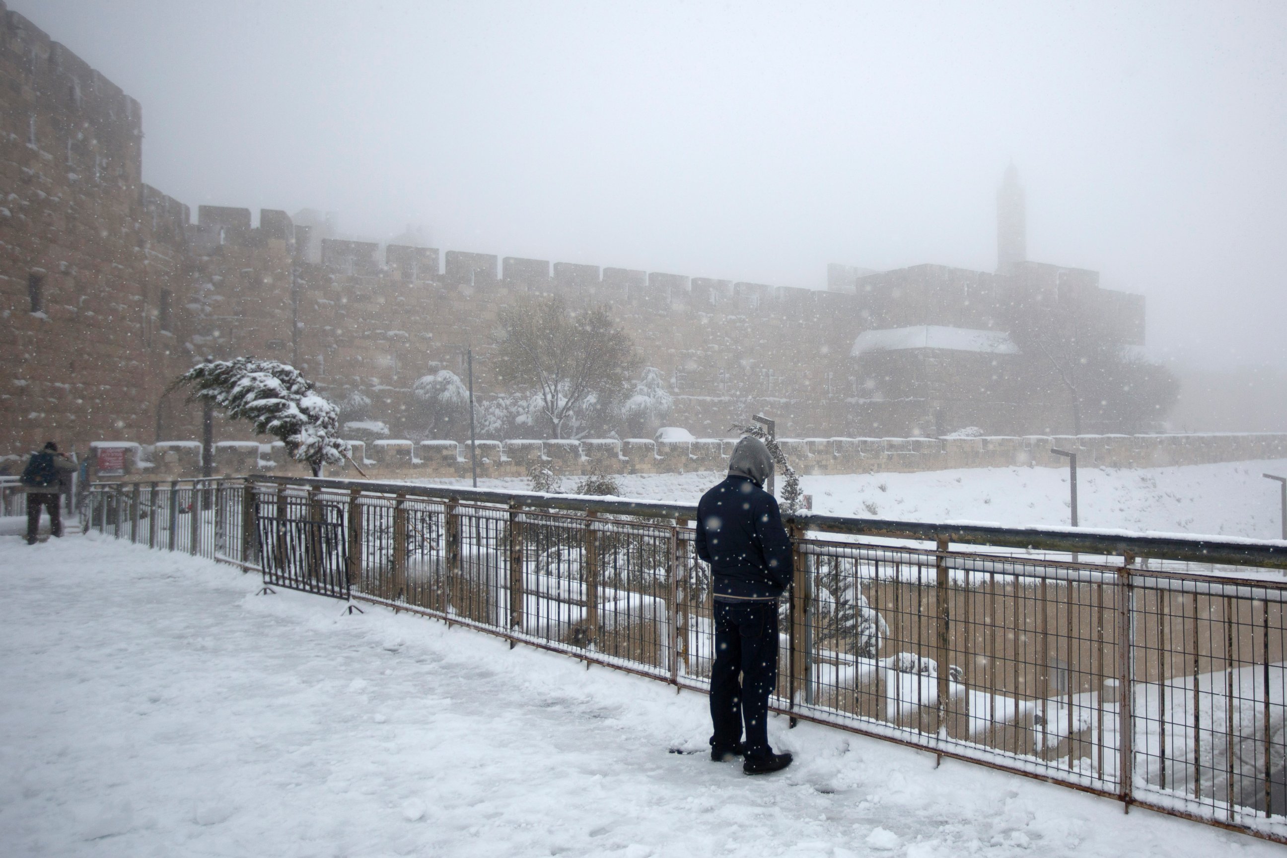 PHOTO: A man stands in the snow near the Tower of David in Jerusalem's Old City, Feb. 20, 2015.