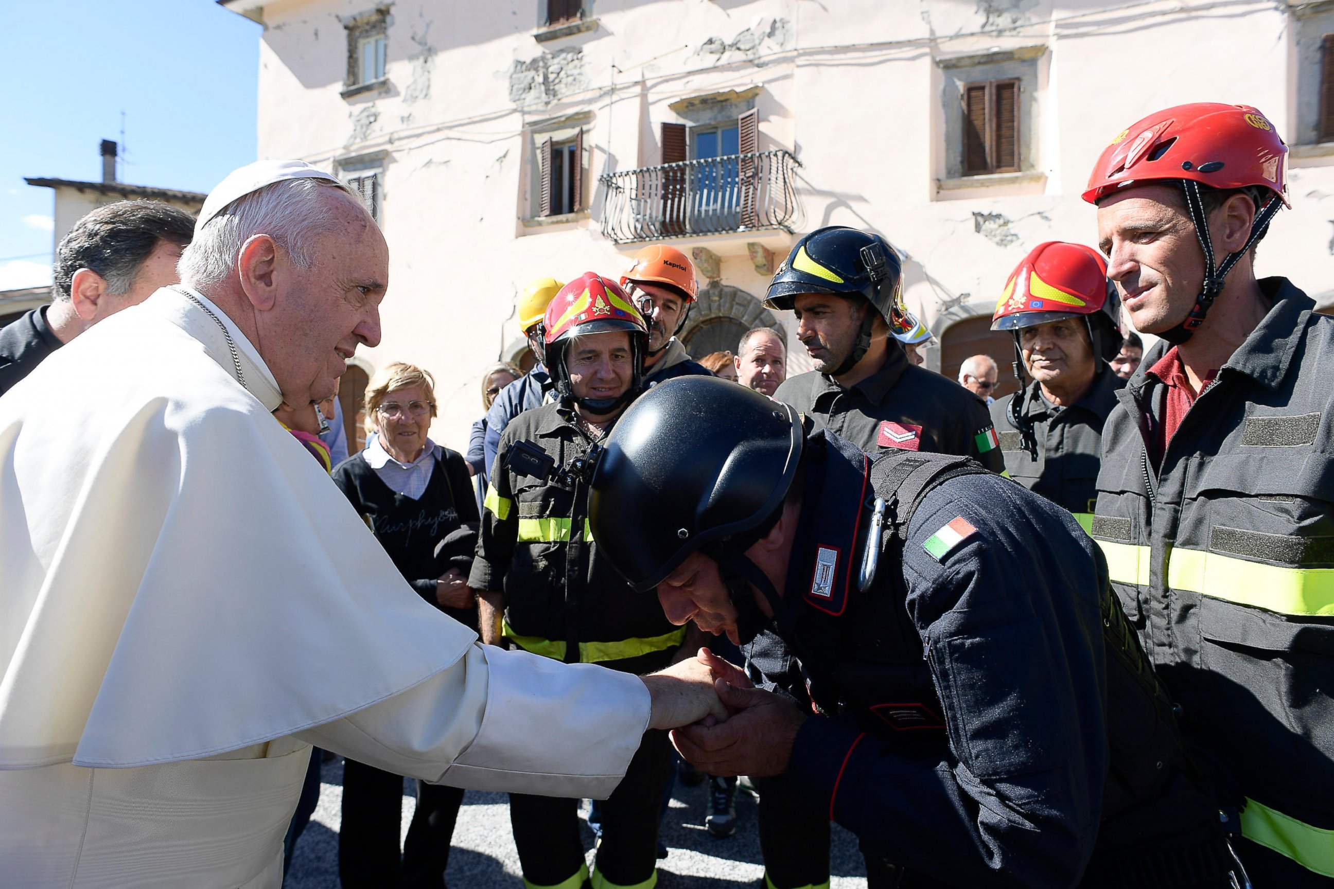 PHOTO: A Carabiniere paramilitary police officer kisses Pope Francis' hand in the village of Accumoli, Italy, Oct. 4, 2016. 