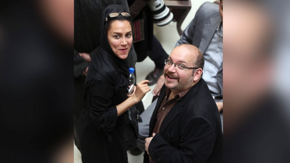 Jason Rezaian, right, an Iranian-American correspondent for the Washington Post, and his wife Yeganeh Salehi, an Iranian correspondent for the Abu Dhabi-based daily newspaper, The National, smile as they attend a presidential campaign of President Hassan Rouhani in Tehran, Iran, April 11, 2013. 