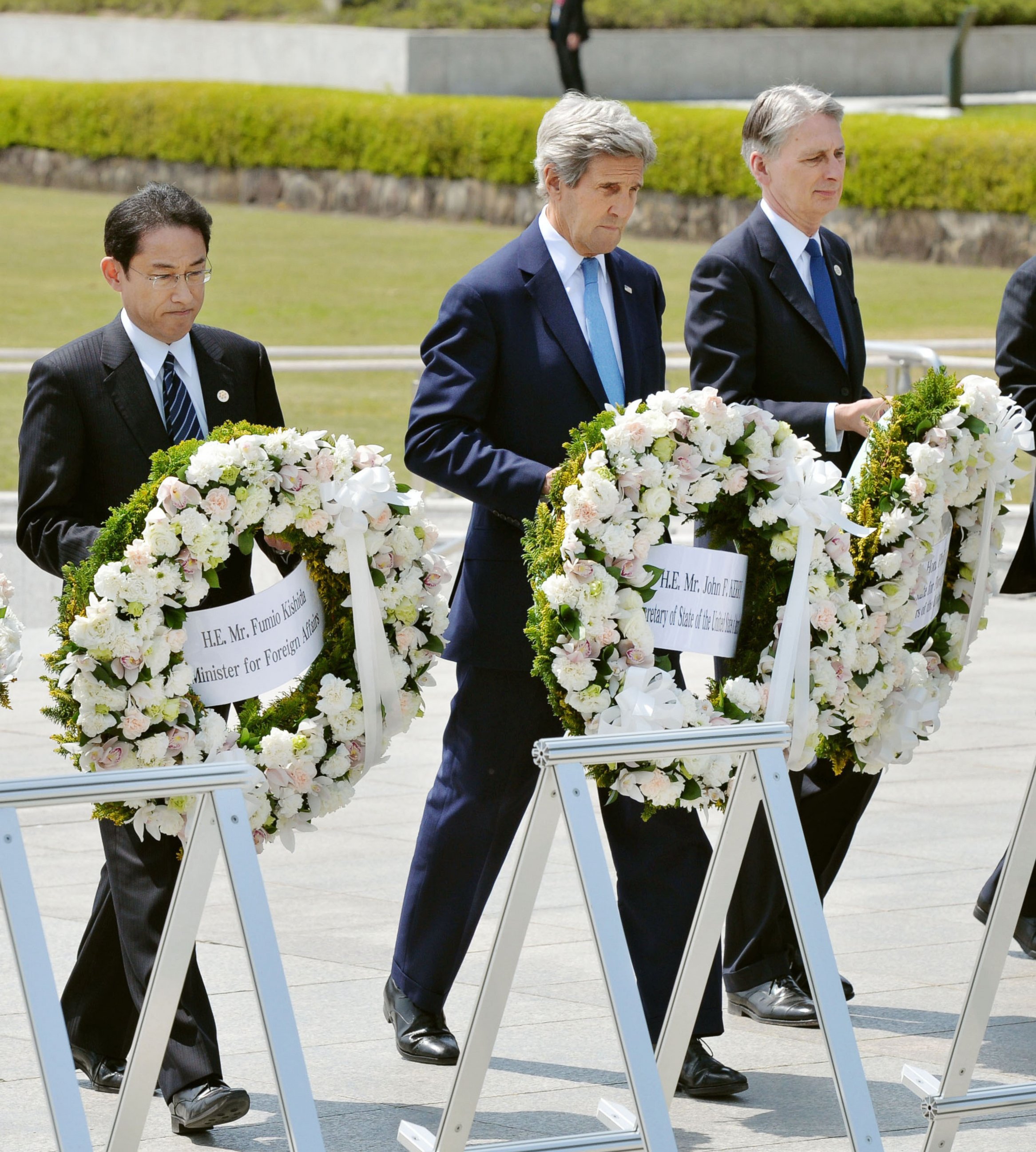 PHOTO: From left, Japan's Foreign Minister Fumio Kishida, U.S. Secretary of State John Kerry and Britain's Foreign Minister Philip Hammond carry wreaths to offer at the cenotaph at Hiroshima Peace Memorial Park in Hiroshima, western Japan, April 11, 2016.