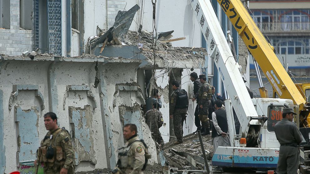 Afghan security forces inspect the site of a Taliban-claimed deadly suicide attack in Kabul, Afghanistan, April 19, 2016. Armed militants in Afghanistan have staged a coordinated assault on a key government security agency in the capital Tuesday morning, killing many and wounding more than 320 people. (AP Photo/Massoud Hossaini)