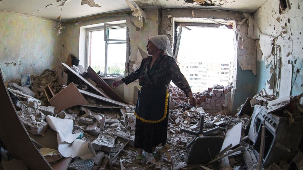 Valentina, who gave only her first name, gestures in a flat of her neighbor who was injured during shelling in the city of Kramatorsk, Donetsk region, eastern Ukraine, Thursday, July 3, 2014.