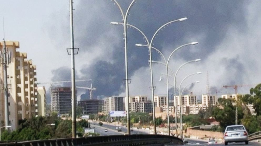 In this image made from video by The Associated Press, smoke rises from the direction of Tripoli airport in Tripoli, Libya, Sunday, July 13, 2014. The State Department evacuated its embassy in Tripoli Saturday, July 26, 2014, amid worsening clashes between rival militias.