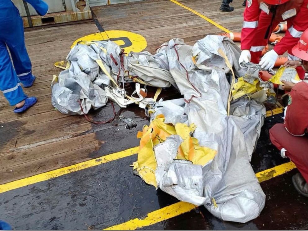 PHOTO: In this photo released by Indonesian Disaster Mitigation Agency (BNPB) rescuers inspect debris believed to be from Lion Air passenger jet that crashed off West Java on Monday, Oct. 29, 2018. 