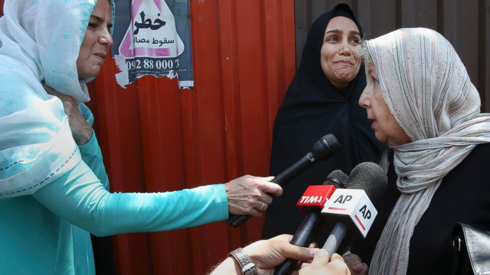 Mary Rezaian, right, mother of detained Washington Post correspondent Jason Rezaian, speaks to journalists as Jason's wife Yeganeh Salehi, at rear, weeps, following a hearing at the Revolutionary Court  in Tehran, Iran, July 13, 2015.