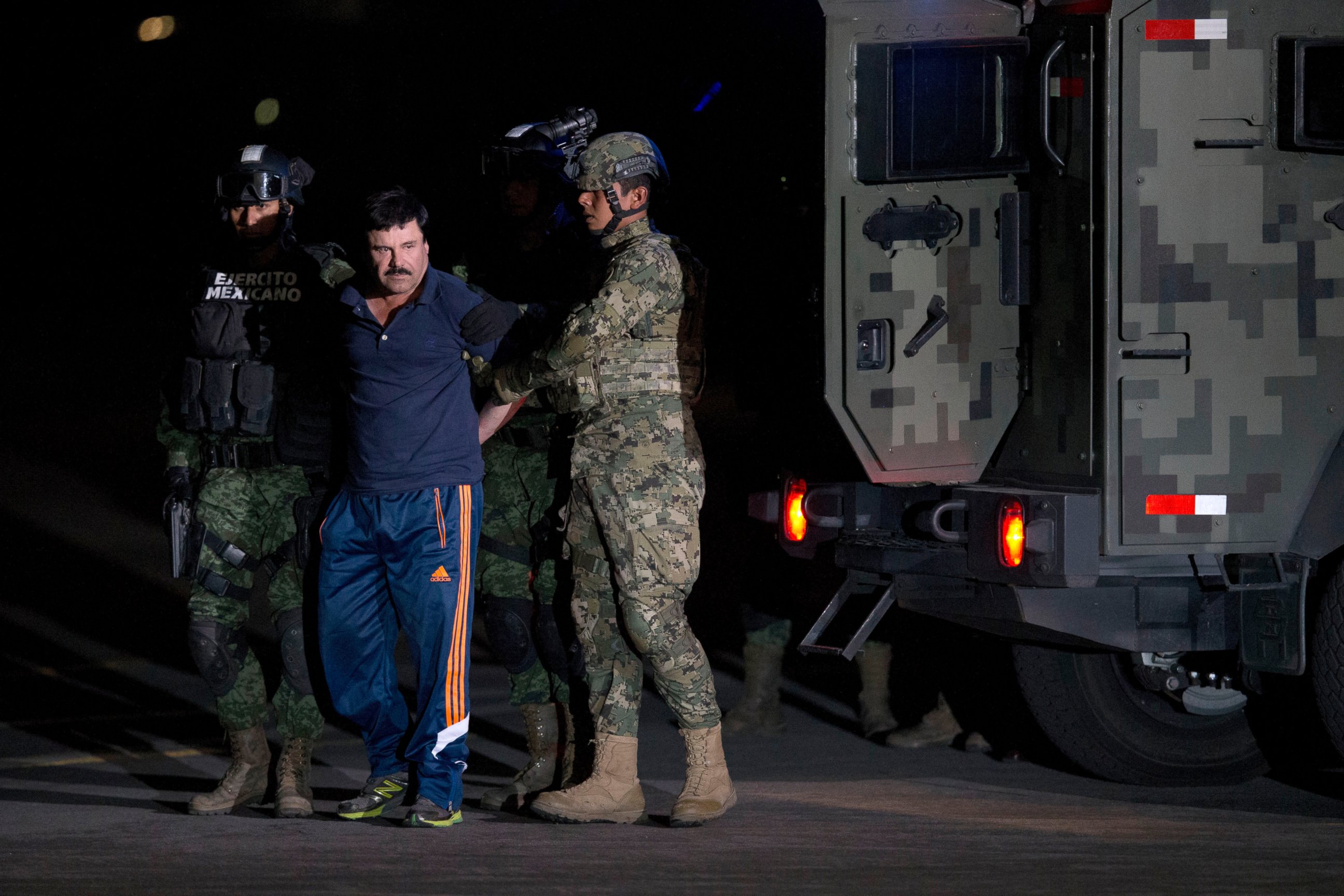 PHOTO: Mexican drug lord Joaquin "El Chapo" Guzman is escorted by soldiers and marines to a waiting helicopter, at a federal hangar in Mexico City, Jan. 8, 2016. 