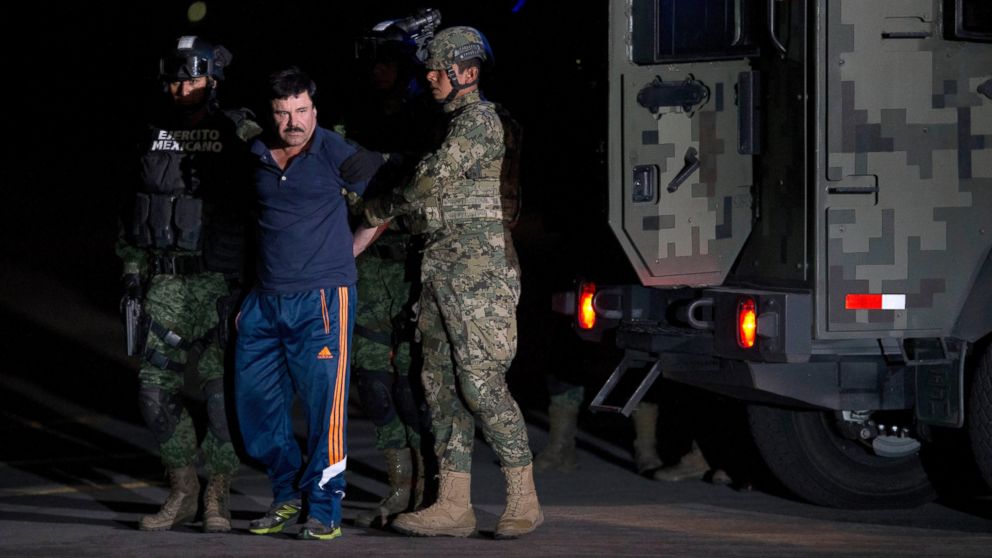 PHOTO: Mexican drug lord Joaquin "El Chapo" Guzman is escorted by soldiers and marines to a waiting helicopter, at a federal hangar in Mexico City, Friday, Jan. 8, 2016. 