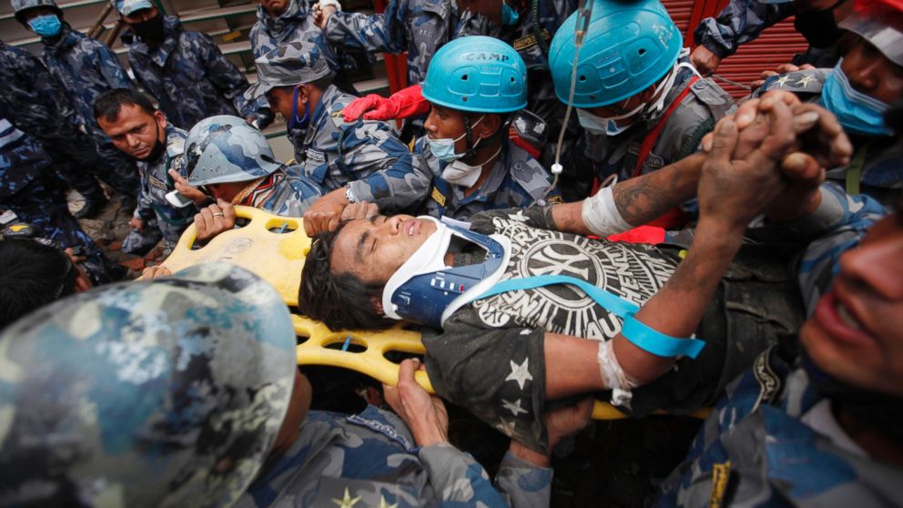 A survivor is carried on a stretcher after being rescued by Nepalese policemen and U.S. rescue workers from a building that collapsed five days ago in Kathmandu, Nepal, April 30, 2015.