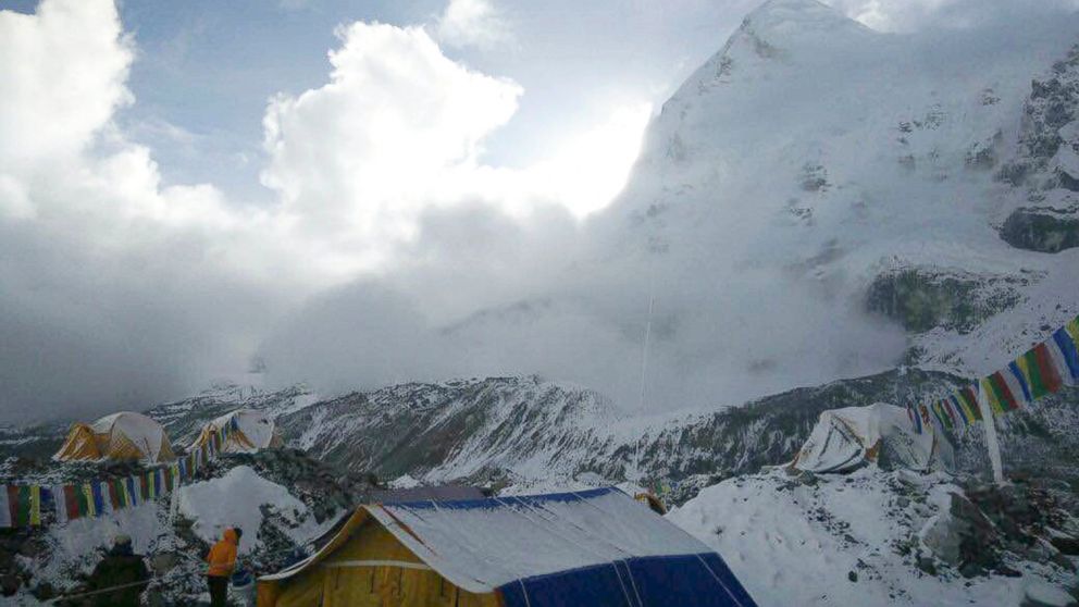 This photo provided by Azim Afif, shows a small avalanche on Pumori mountain as seen from Everest Base Camp, Nepal on Sunday, April 26, 2015.