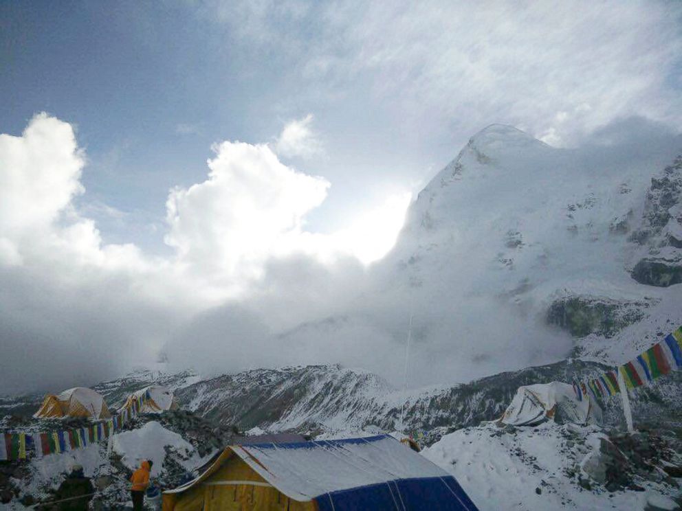 This photo provided by Azim Afif, shows a small avalanche on Pumori mountain as seen from Everest Base Camp, Nepal on Sunday, April 26, 2015. 