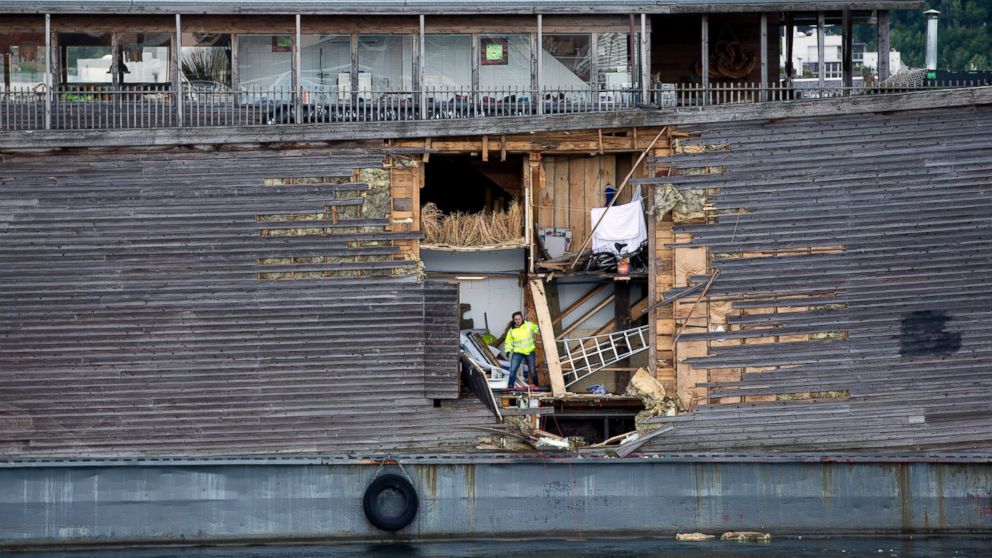 PHOTO: A crew member inspects the damage of the hull of a wooden exhibition ship built as a representation of Noah's Ark after it crashed into a moored Coast Guard vessel in Oslo harbor, June 10, 2016, in Oslo.