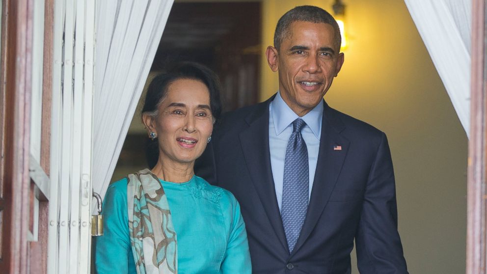 U.S. President Barack Obama, right, walks out with Myanmar's opposition leader Aung San Suu Kyi at her home before the start of their joint news conference in Yangon, Myanmar, Nov. 14, 2014.