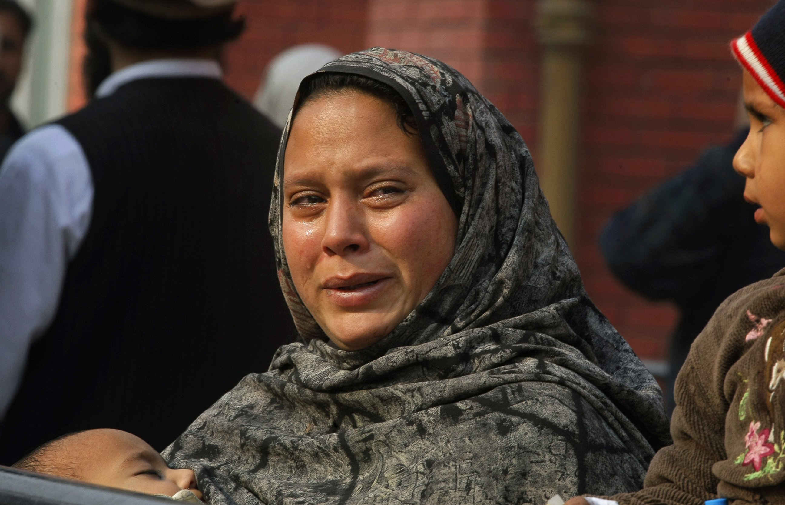 PHOTO: A Pakistani woman weeps as she waits at a hospital, where victims of a Taliban attack are being treated in Peshawar, Pakistan, Dec. 16, 2014.