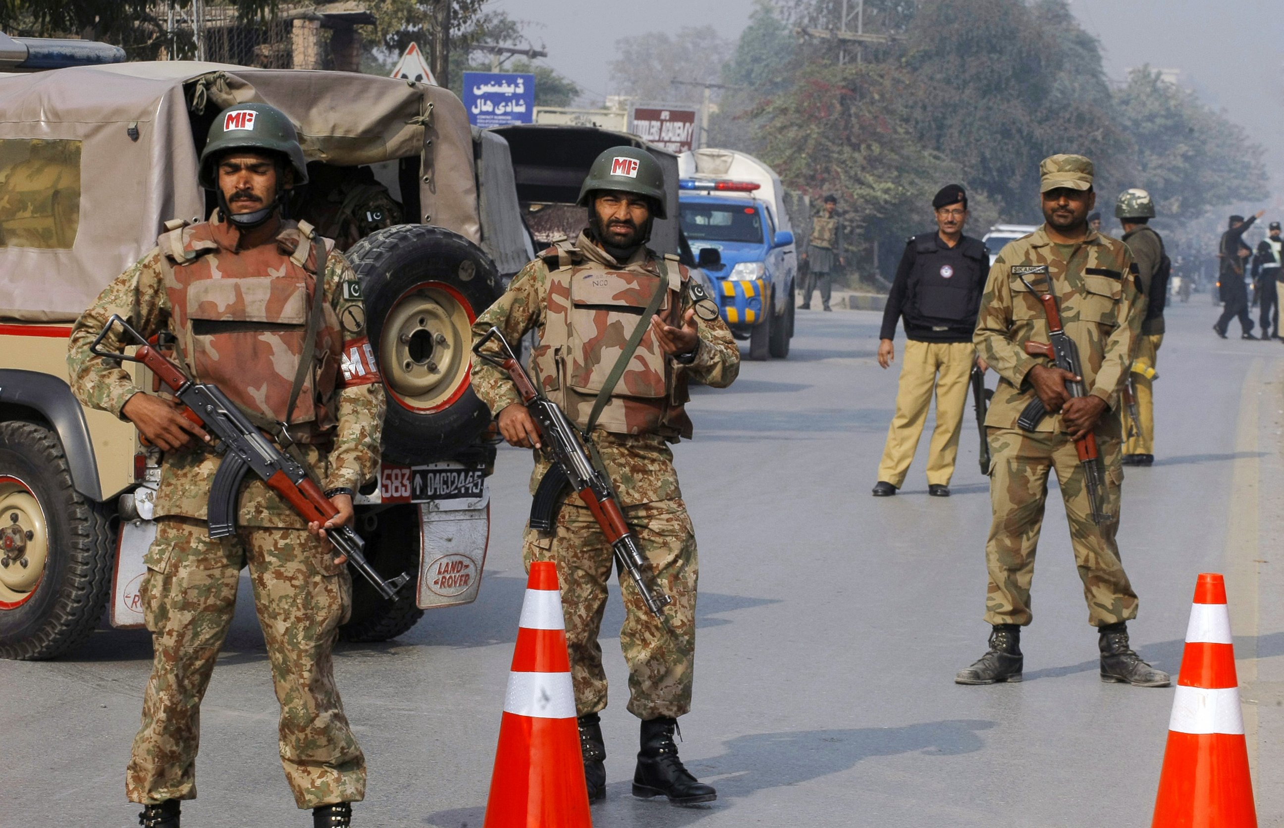 PHOTO: Pakistani army troops cordon off a road leading to a school under attack by Taliban gunmen in Peshawar, Pakistan, Dec. 16, 2014.