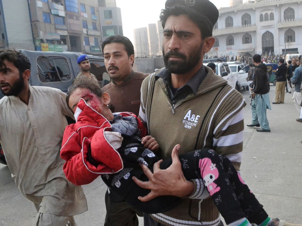 PHOTO: A Pakistani girl, who was injured in a Taliban attack in a school, is rushed to a hospital