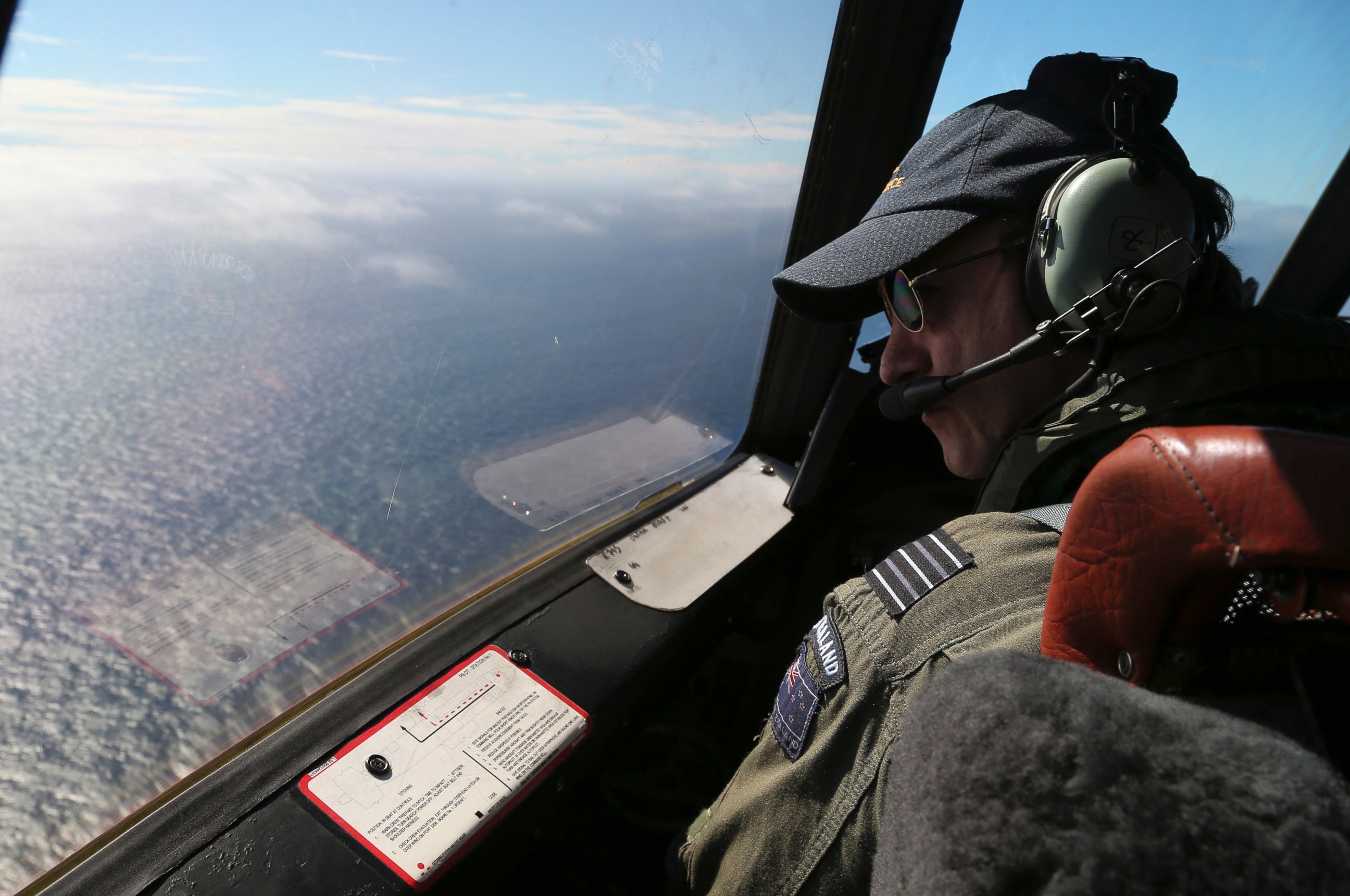 PHOTO: Royal New Zealand Air Force P-3 Orion's captain, Wing Comdr. Rob Shearer watches out of the window of his aircraft while searching for the missing Malaysia Airlines Flight MH370 in the southern Indian Ocean, Monday, March 31, 2014.