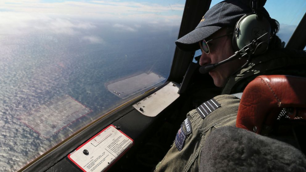 The Royal New Zealand Air Force P-3 Orion's captain, Wing Cmdr. Rob Shearer, watches out of the window of his aircraft while searching for the missing Malaysia Airlines Flight MH370 in the southern Indian Ocean, Monday, March 31, 2014.