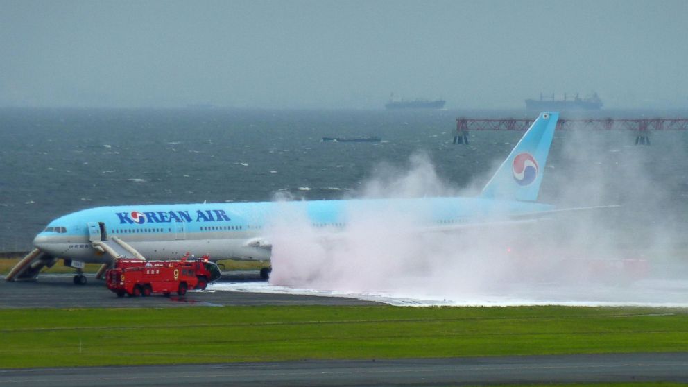 PHOTO: White smoke rises from an engine of a Korean Air jet as firefighters battle an apparent engine fire on the tarmac at Haneda Airport in Tokyo May 27, 2016. All the passengers and crew were evacuated unharmed, Japanese media reported.