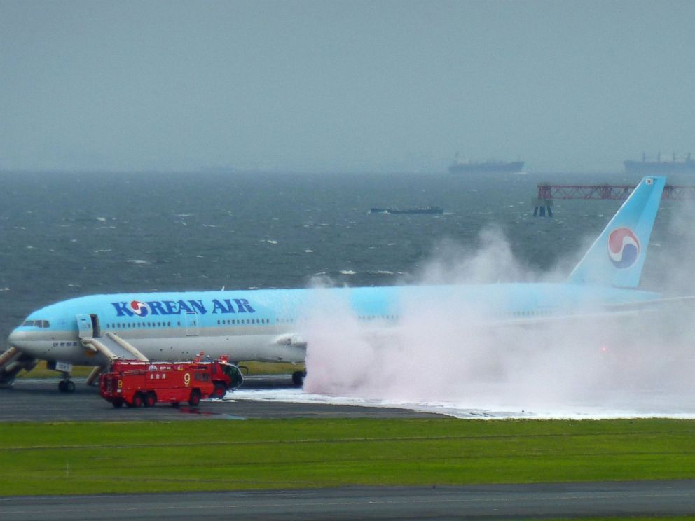 PHOTO: White smoke rises from an engine of a Korean Air jet as firefighters battle an apparent engine fire on the tarmac at Haneda Airport in Tokyo May 27, 2016. All the passengers and crew were evacuated unharmed, Japanese media reported.