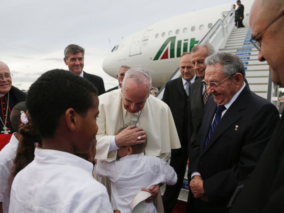 PHOTO: Pope Francis hugs a boy as Cubas President Raul Castro looks on after landing at the airport in Havana, Cuba, Saturday, Sept. 19, 2015.