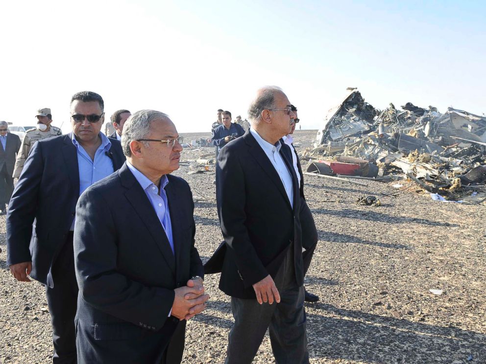 PHOTO: In this photo released by the Prime Ministers office, Sherif Ismail, center, visits the site where a plane crashed in Hassana, Egypt on Saturday, Oct. 31, 2015.